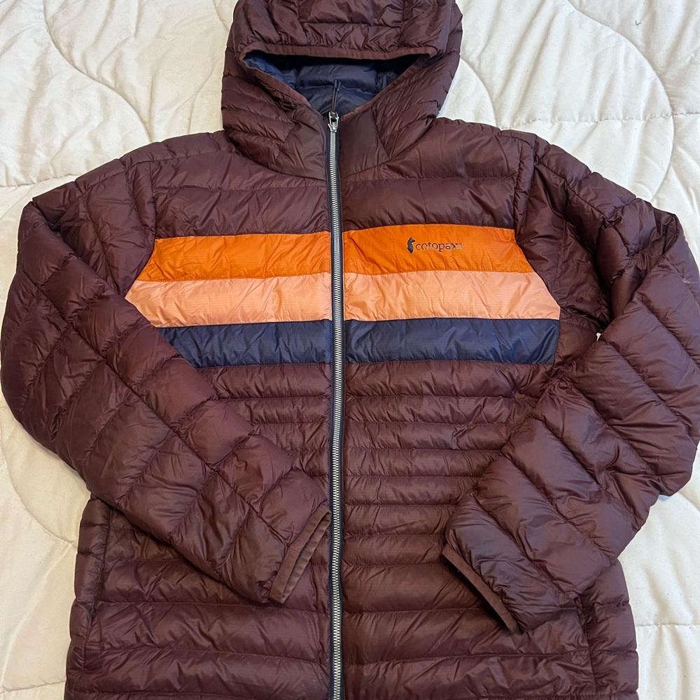 Cotopaxi Brown Puffer Jacket with Orange and Blue Stripes